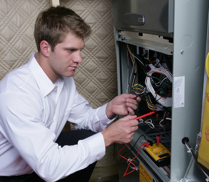 A technician repairing an air conditioner system.