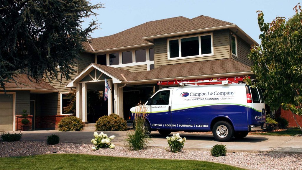 A Campbell service van parked in front of a residence.