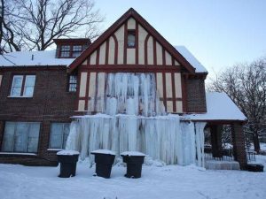 house in the snow with ice covering windows