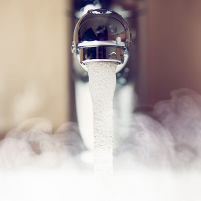 hot water coming from a faucet