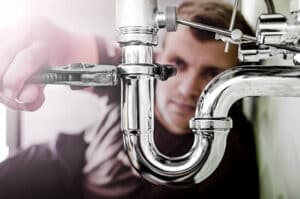 Plumber working on a drain pipe