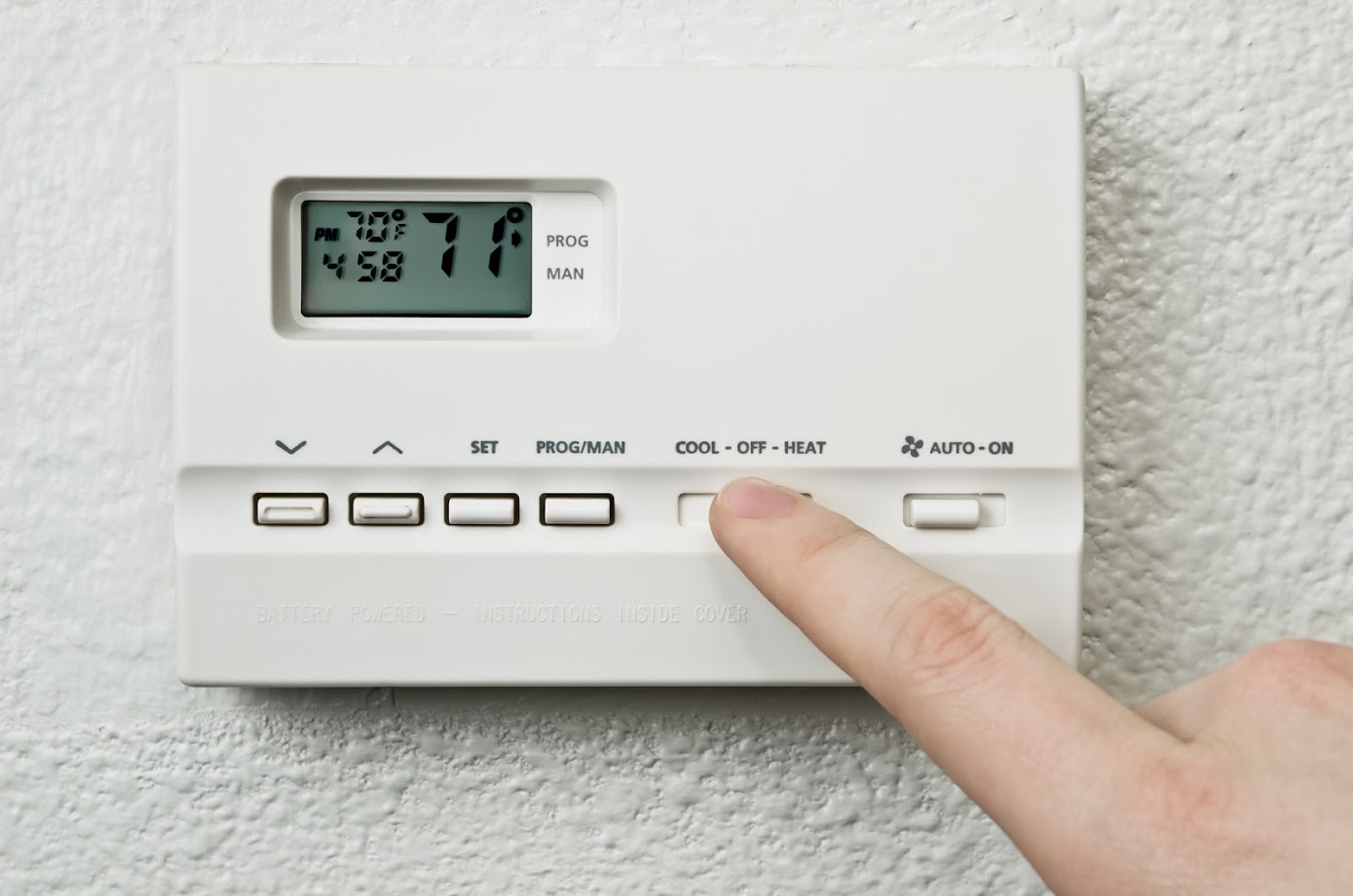 adjusting home thermostat