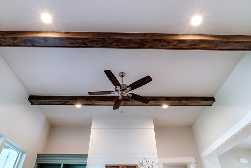ceiling fan installed in living room with high ceilings