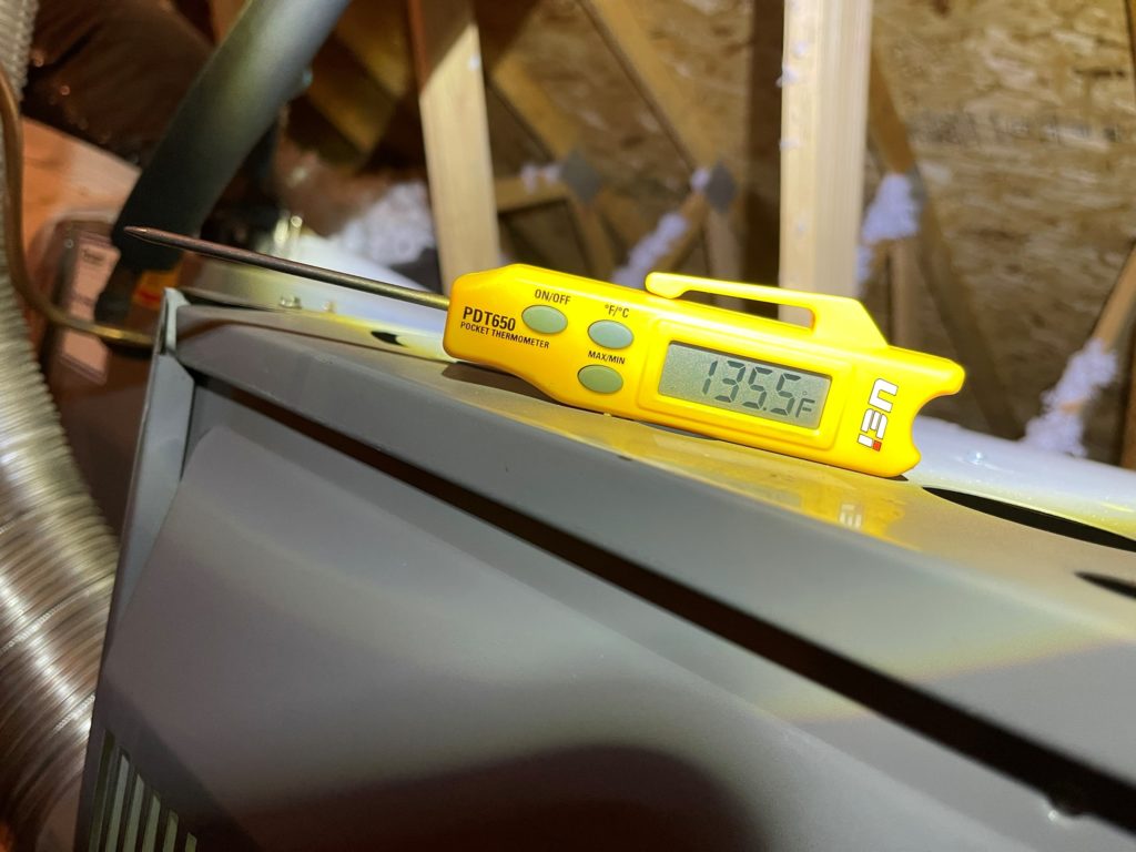 temperature sensor or probe in an attic sitting on a grey hvac unit