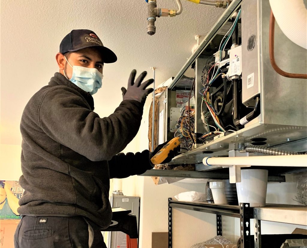 Technician working on a unit inside a home