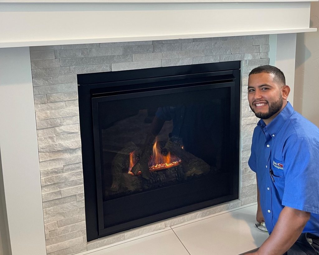 HVAC technician performing a gas fireplace tune-up
