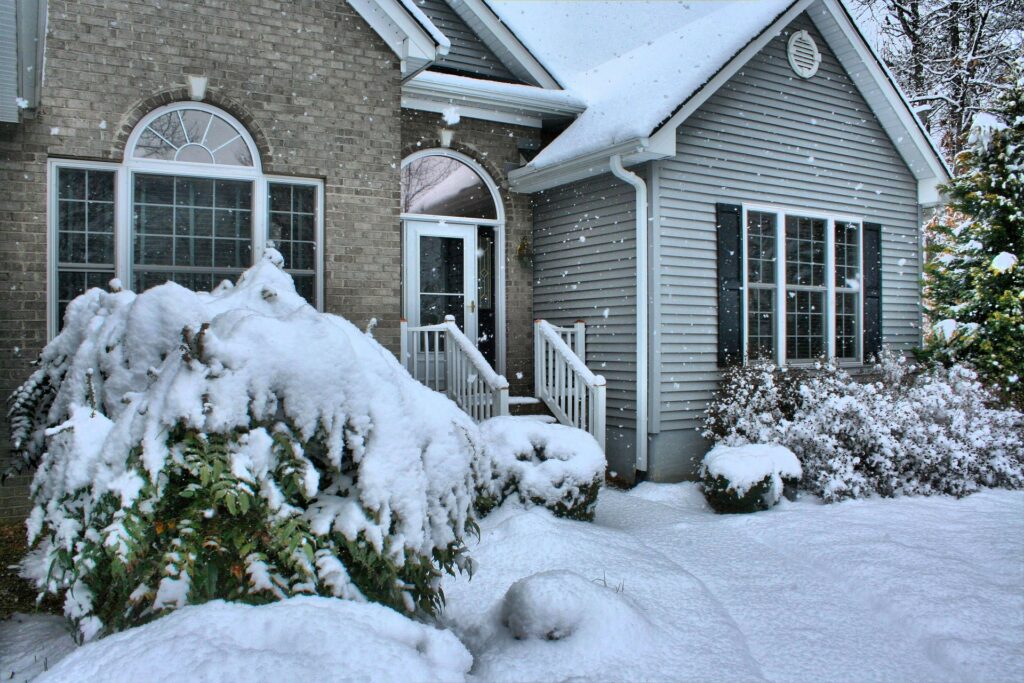 Front view of a residential home covered in snow