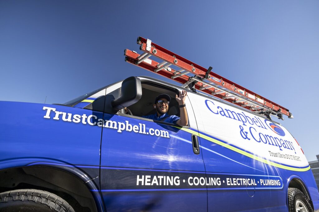 Campbell & Company technician driving van and smiling and waving out window